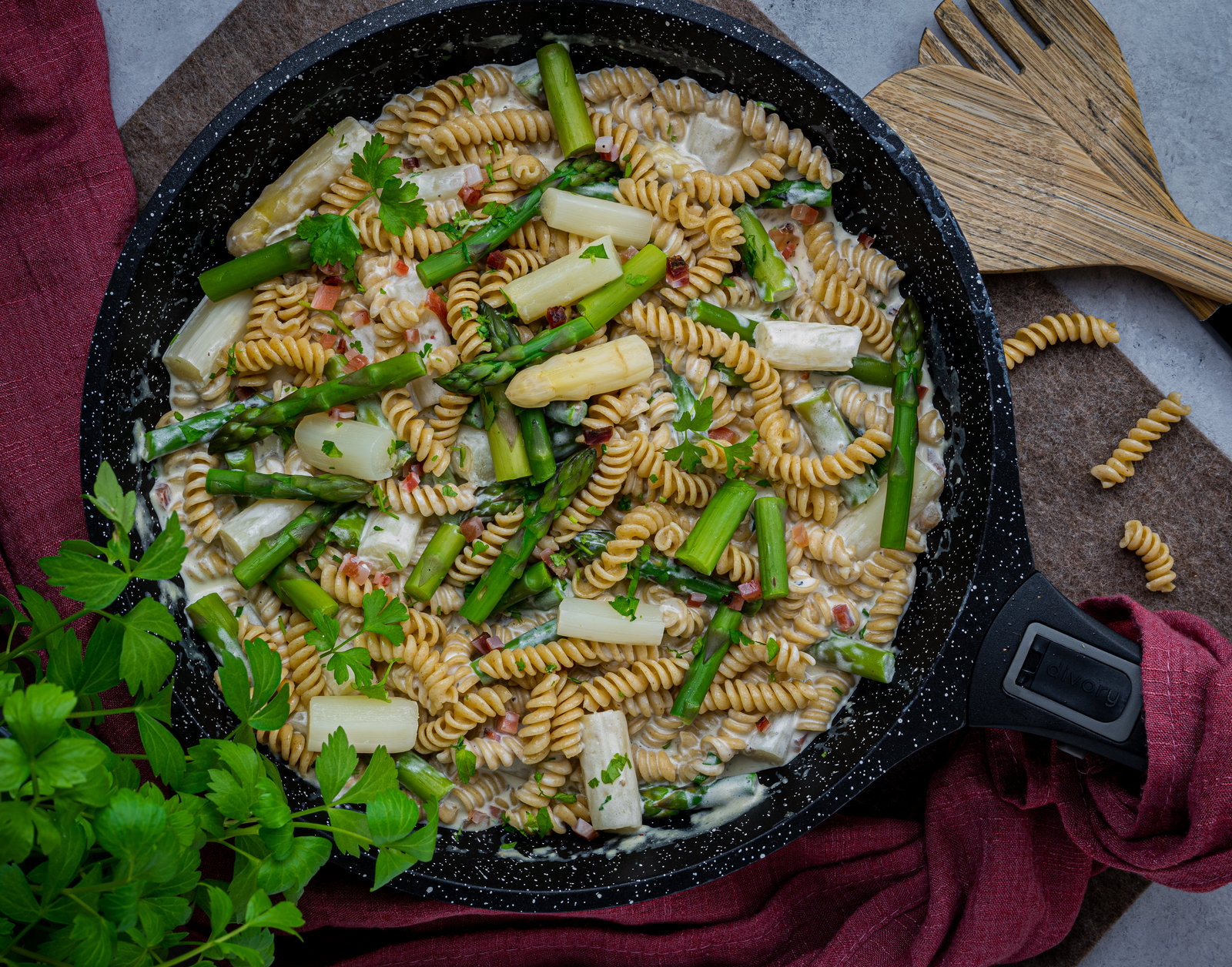 Cremige Nudel-Spargel-Gorgonzola-Pfanne in einer Schale, bestreut mit Petersilie und Parmesan.