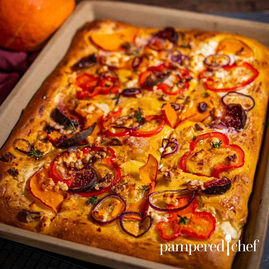 Ein fertig gebackener Dinkelflammkuchen mit Kürbisteig und Belag