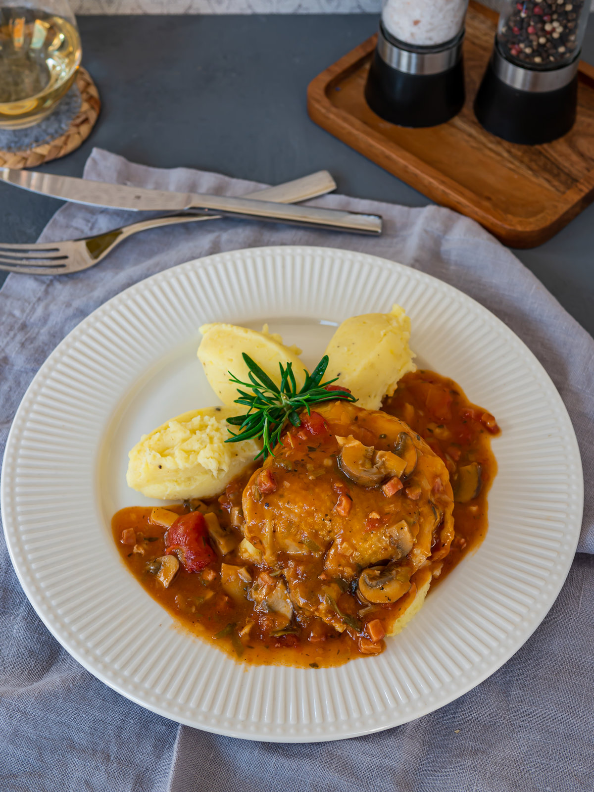 Poulet Chasseur mit Hähnchenkeulen, Speck und Champignons in Tomatensauce
